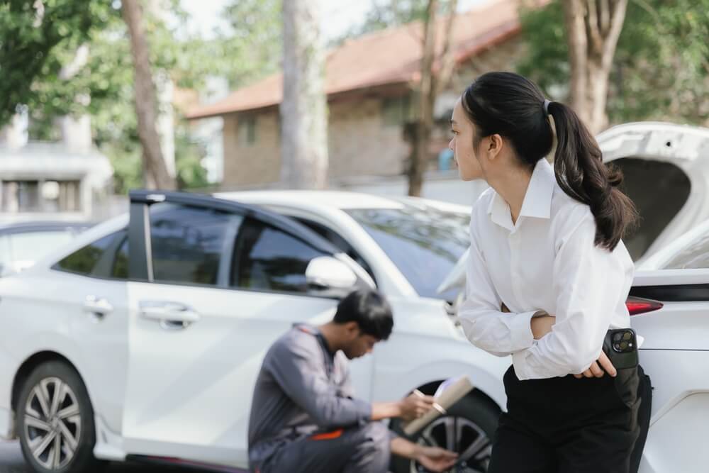 Imagem de uma mulher esperando a avaliação de veículo dela ficar pronta para contratação de um seguro auto.